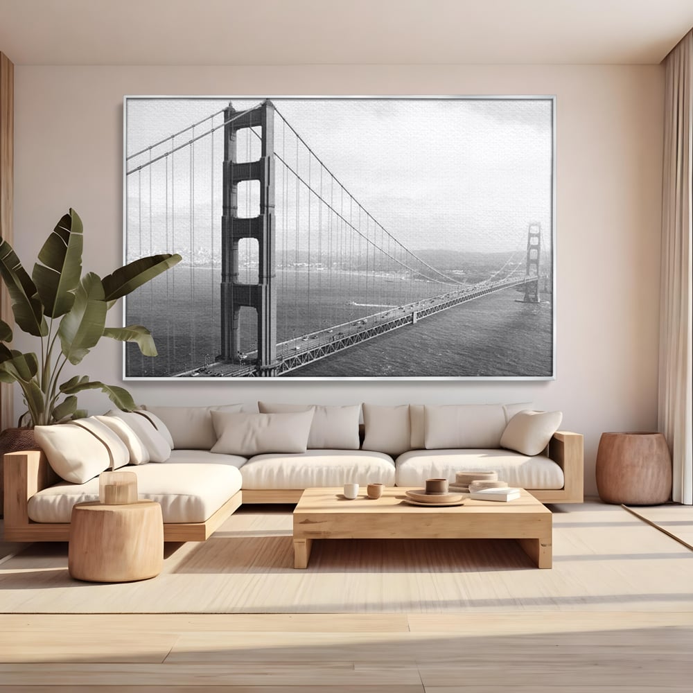 Tablou canvas cu fotografie alb-negru cu podul golden gate, in rama de aluminiu argintiu, pe perete intr-un living